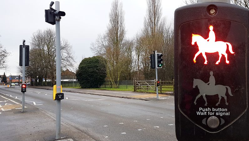 Road with Pegasus crossing with control panel signalling horse riders to wait