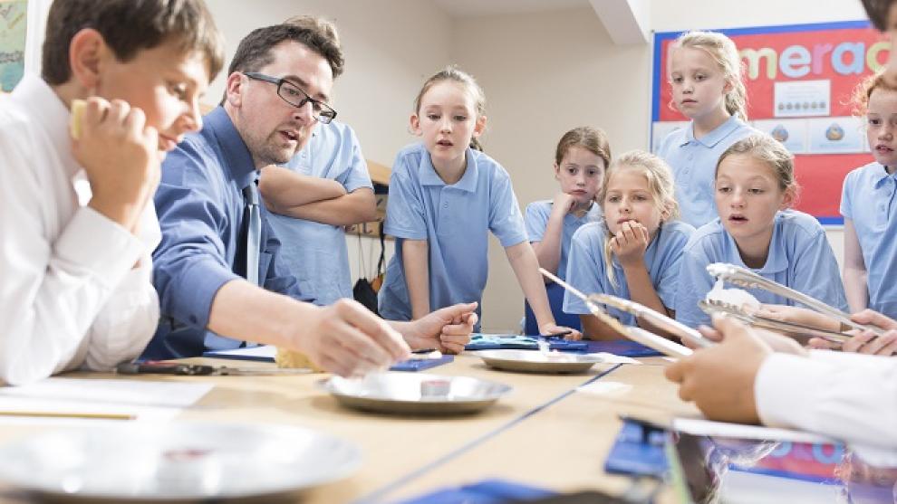 Teacher making a demonstration for a group of young children