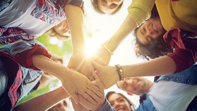 Group of people holding hands showing togetherness