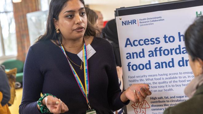 Health Determinants Research Collaboration Leicestershire representative talking to a member of the public during a citizens assembly event