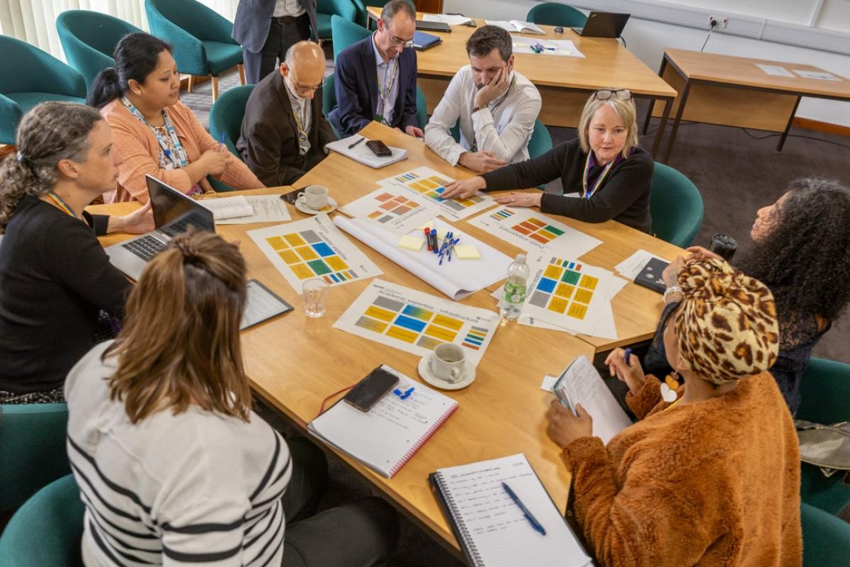 A group of people sitting around a table and having a discussion