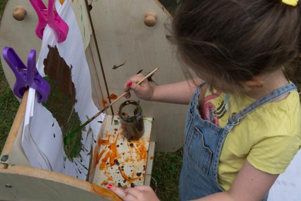 A child painting in the garden
