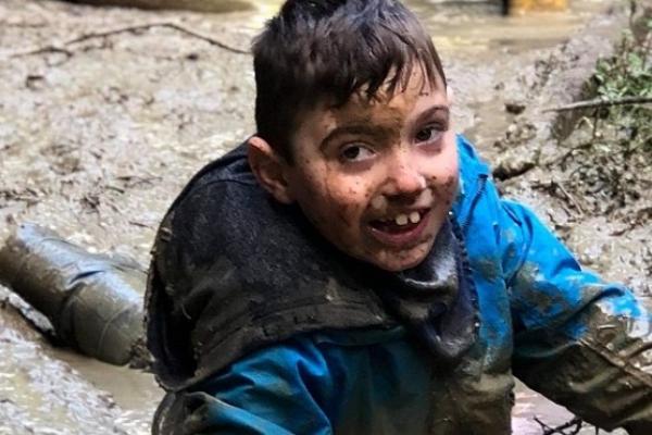 Boy playing in mud